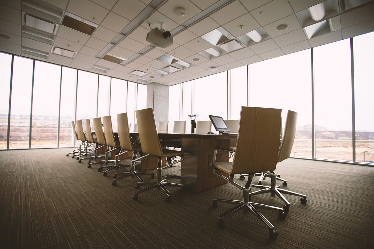 Business office conference room with long table and eighteen chairs for Business Owners Insurance.