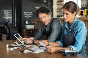 small business owners look at receipts and insurance