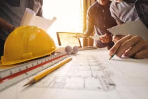 contractors look over building and insurance plans