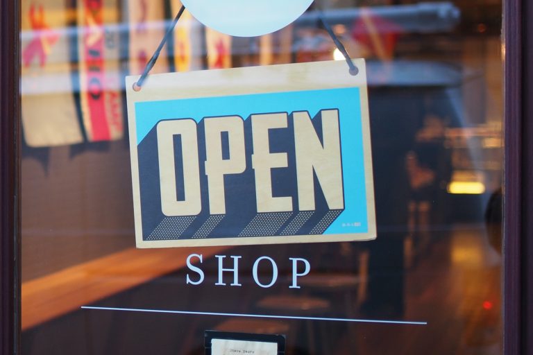 How to Shop for Auto Insurance Without Getting a Headache - open sign on shop door