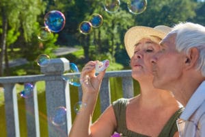 Old people blowing bubbles