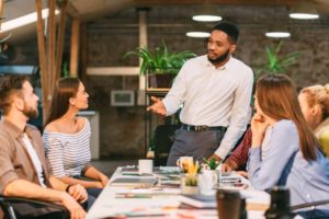 Young boss talking to young employees