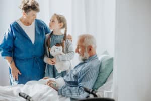 family visiting sick relative in hospital