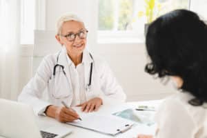 doctor and patient meeting to discuss healthcare open enrollment
