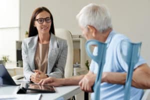 Insurance agent discussing conditions with senior man