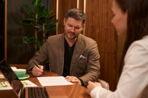 company owner signing document for business insurance coverage