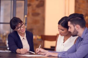 insurance agent and young couple discussing general liability insurance limits