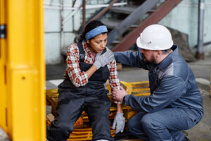 Foreman giving first aid to worker