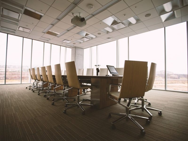 Business office conference room with long table and eighteen chairs for Business Owners Insurance.