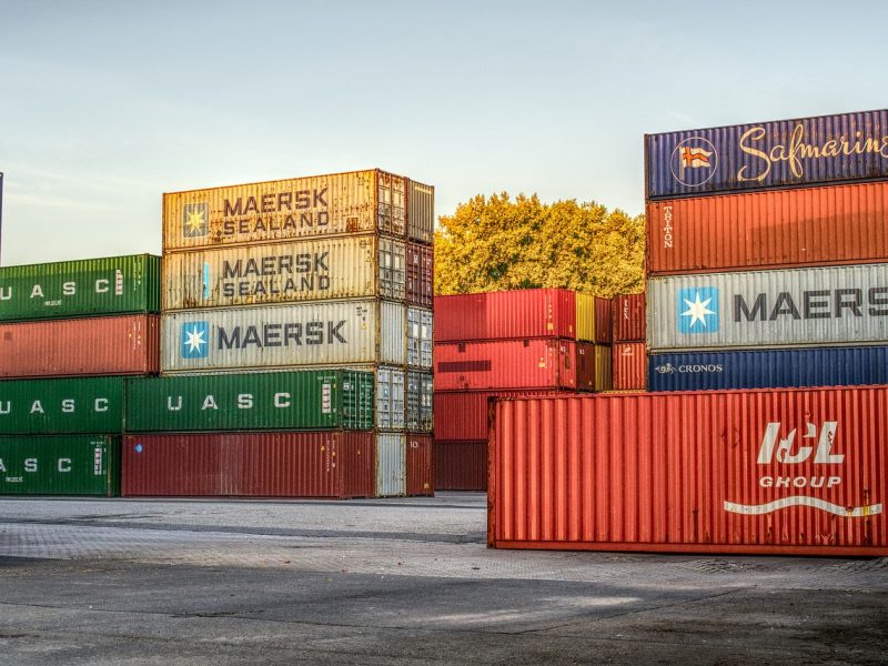 Multiple stacked cargo bins sitting outside for Inland Marine Insurance.