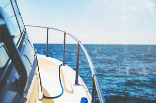 Watercraft Insurance Up-close view from side of boat looking forward at the sea for Watercraft Insurance.